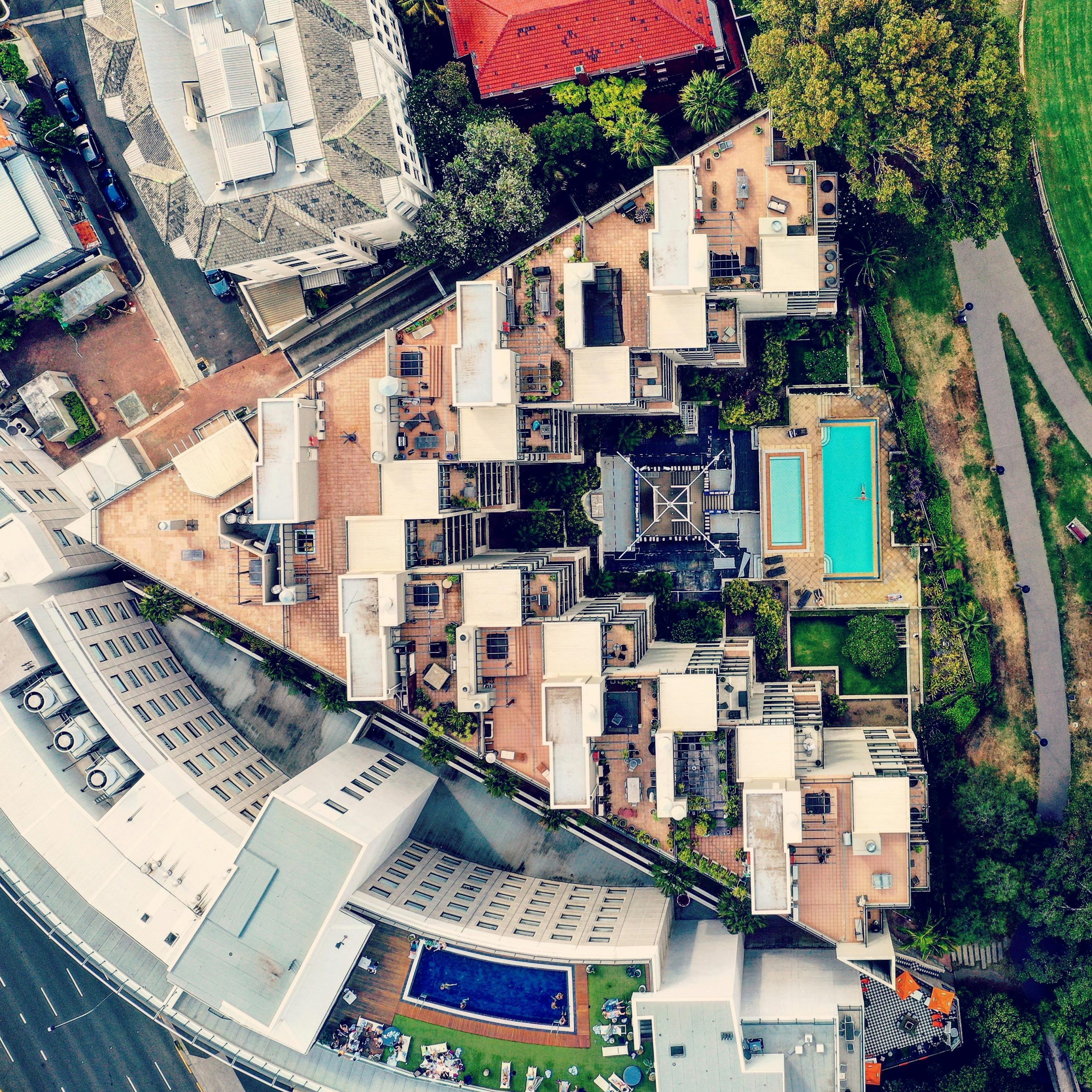 Explore the vibrant cityscape of Rushcutters Bay, showcasing modern architecture and lush greenery from above.